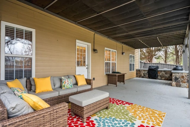 view of patio featuring grilling area, fence, and an outdoor hangout area