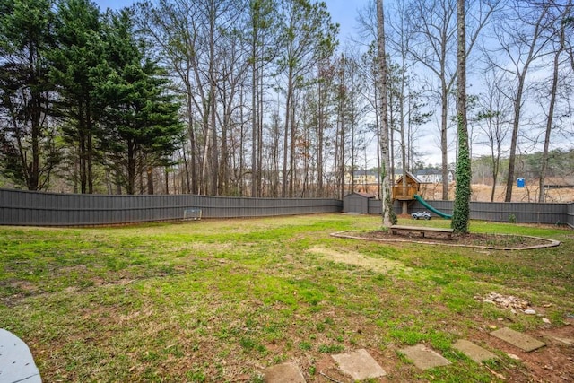 view of yard featuring a fenced backyard and a playground