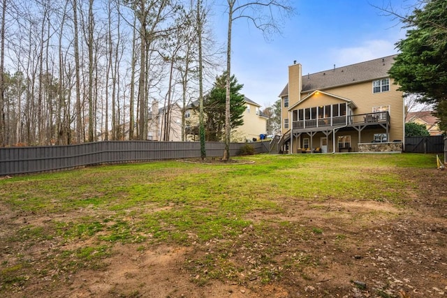 view of yard featuring stairway, a fenced backyard, and a sunroom