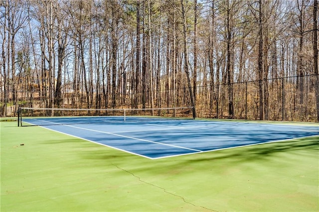 view of tennis court with fence