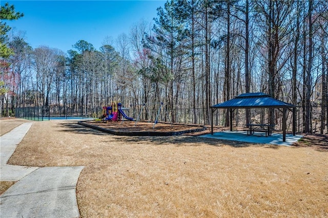 community playground with a gazebo, a lawn, and fence