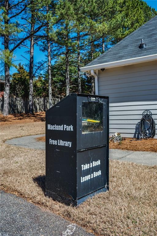 exterior details with a downspout and gutters