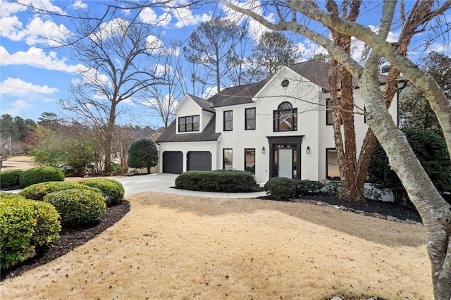 view of front of house with a garage and concrete driveway