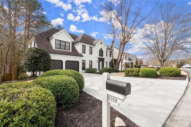 view of front of property with driveway, an attached garage, and a residential view