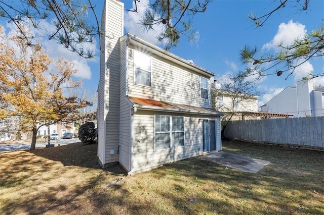 back of property with a yard