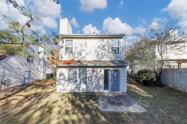 back of house with a lawn