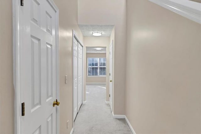 hallway with light colored carpet