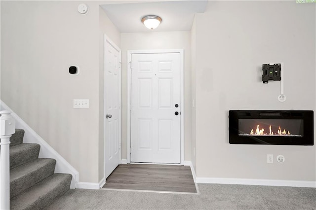 entrance foyer with carpet flooring