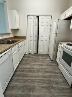 3609 Ginnis Rd, Atlanta, GA 30331 - kitchen featuring white appliances, white cabinetry, and dark wood-type flooring
