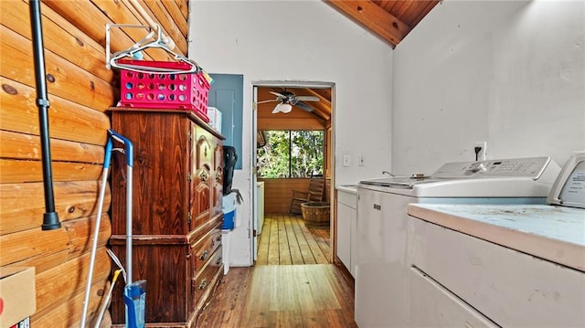 laundry room featuring ceiling fan, hardwood / wood-style flooring, wooden ceiling, independent washer and dryer, and wood walls