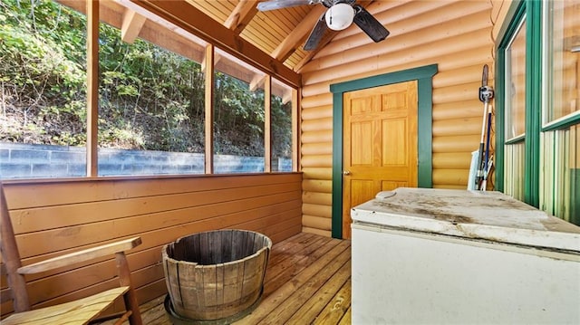 sunroom featuring beam ceiling, ceiling fan, and wooden ceiling