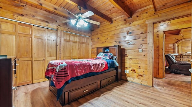 bedroom featuring ceiling fan, light hardwood / wood-style flooring, beamed ceiling, and wood ceiling