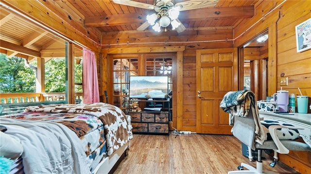 bedroom with light hardwood / wood-style flooring, beamed ceiling, and wood ceiling