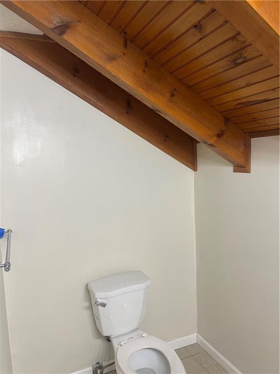 bathroom with tile patterned flooring, toilet, and wooden ceiling