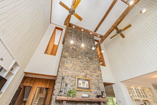 interior space with beamed ceiling and ceiling fan