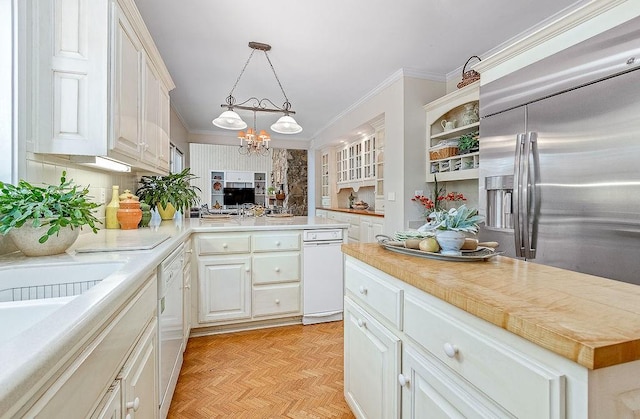 kitchen with white cabinets, white dishwasher, light parquet flooring, and an inviting chandelier