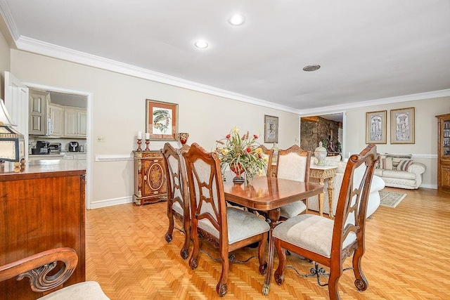 dining space featuring light parquet floors and crown molding