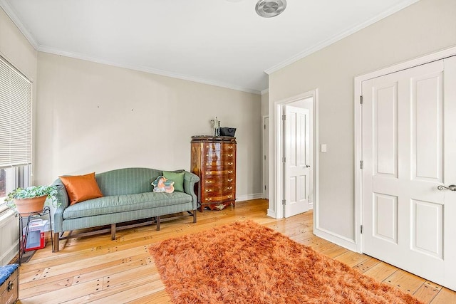 living area featuring light hardwood / wood-style floors and ornamental molding