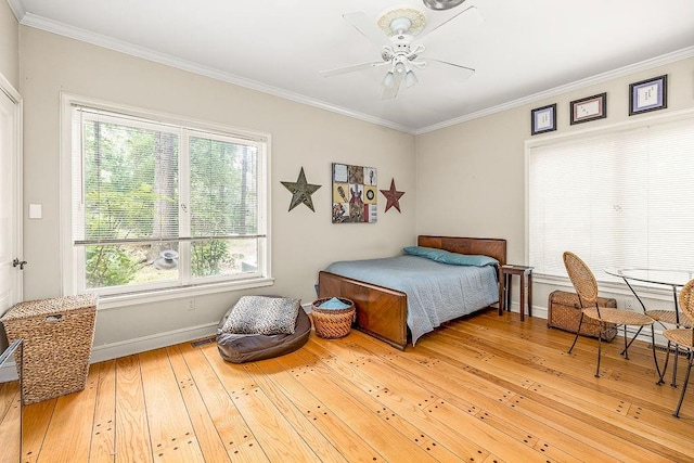 bedroom featuring ornamental molding, ceiling fan, and light hardwood / wood-style floors