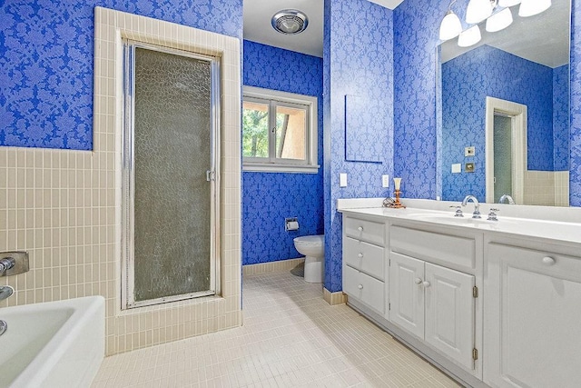 bathroom featuring vanity, tile patterned flooring, and toilet