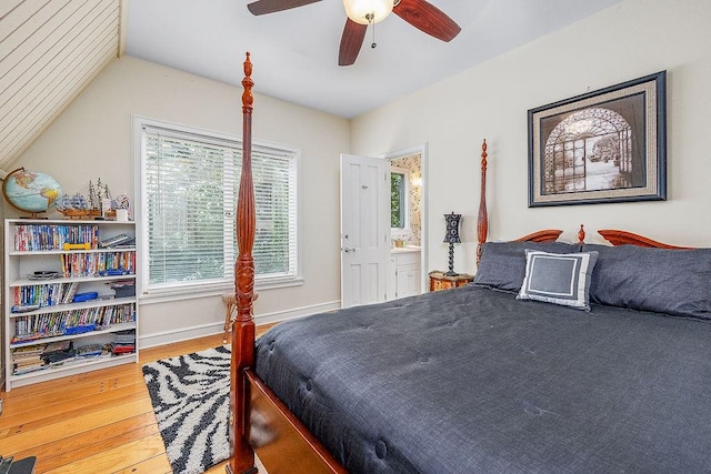 bedroom with hardwood / wood-style flooring, ensuite bathroom, and ceiling fan