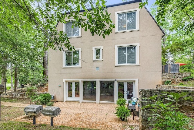 rear view of house featuring a patio and french doors