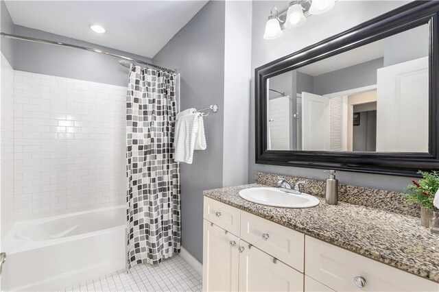 bathroom featuring tile patterned flooring, vanity, and shower / tub combo