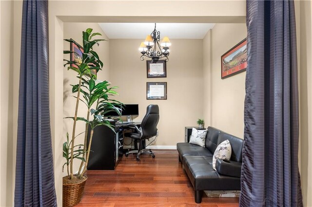 office space with dark hardwood / wood-style flooring and a notable chandelier