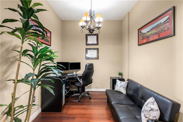 home office featuring a notable chandelier and dark wood-type flooring