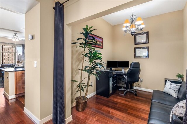 home office featuring dark hardwood / wood-style flooring and ceiling fan with notable chandelier