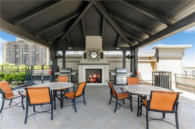 view of patio / terrace with a gazebo, a grill, and exterior fireplace