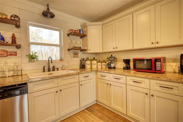 kitchen featuring sink, light hardwood / wood-style flooring, light stone countertops, and dishwasher