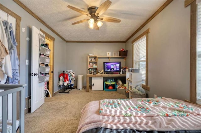 bedroom with crown molding, light carpet, and a textured ceiling