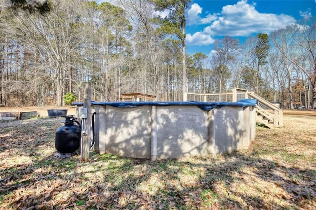 view of side of property featuring a covered pool