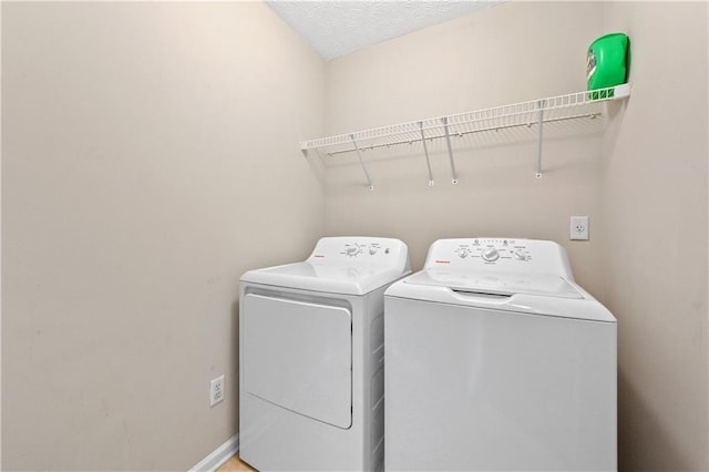 clothes washing area with independent washer and dryer