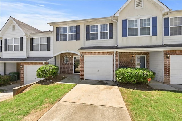 view of property with a garage and a front yard