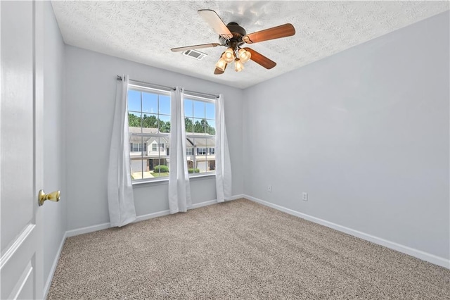 unfurnished room with carpet flooring, a textured ceiling, and ceiling fan