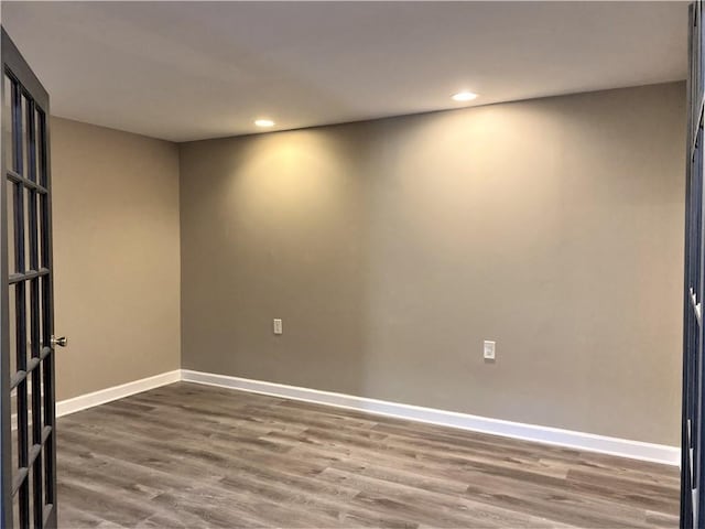 unfurnished room featuring baseboards, recessed lighting, and wood finished floors