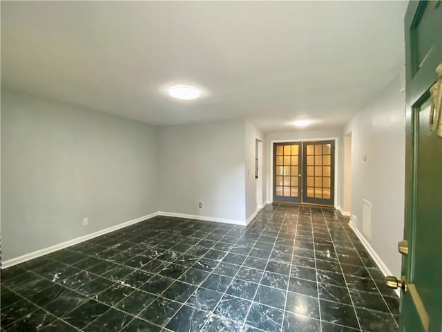 unfurnished room featuring french doors, marble finish floor, baseboards, and visible vents