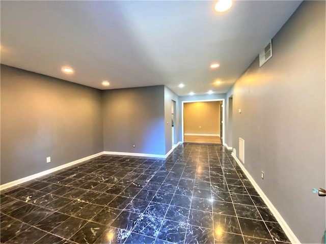 interior space with baseboards, recessed lighting, and marble finish floor