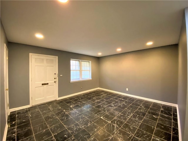 foyer featuring baseboards, recessed lighting, and marble finish floor