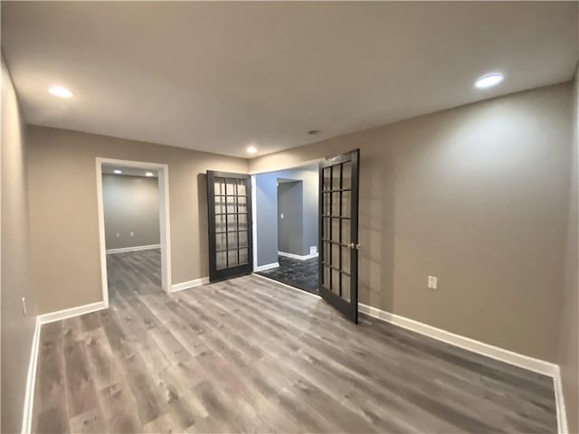 unfurnished room with french doors, recessed lighting, baseboards, and wood finished floors