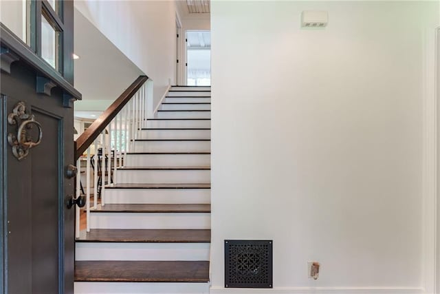 staircase with a high ceiling