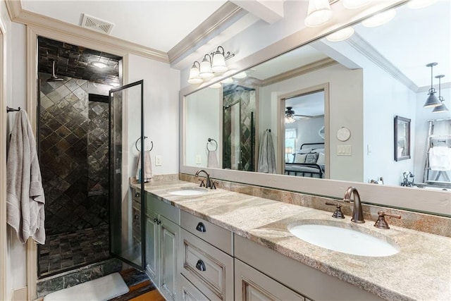 bathroom with ceiling fan, ornamental molding, vanity, and a shower with shower door