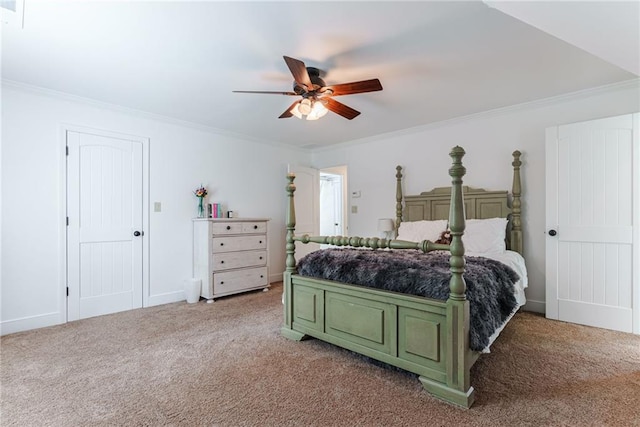 carpeted bedroom with ceiling fan and ornamental molding