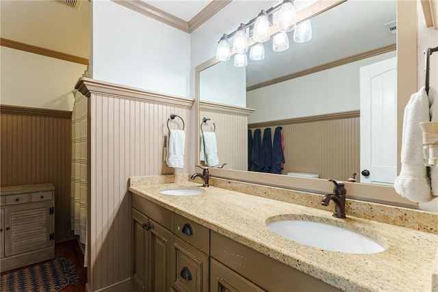 bathroom with toilet, ornamental molding, and vanity