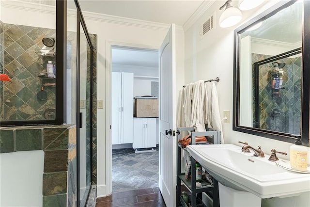 bathroom featuring sink, ornamental molding, wood-type flooring, and walk in shower