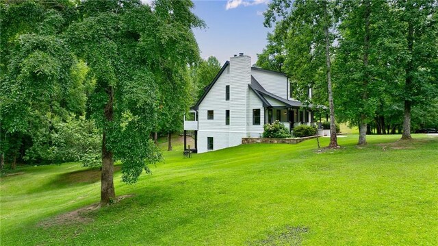 view of side of property with a lawn