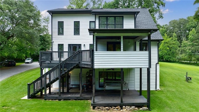 back of property featuring a yard and a wooden deck