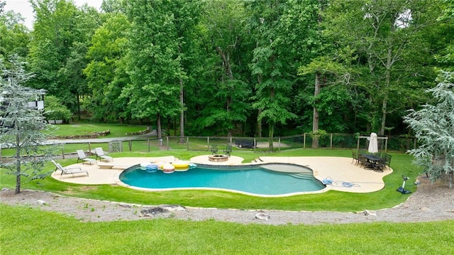 view of pool with a patio area and a yard